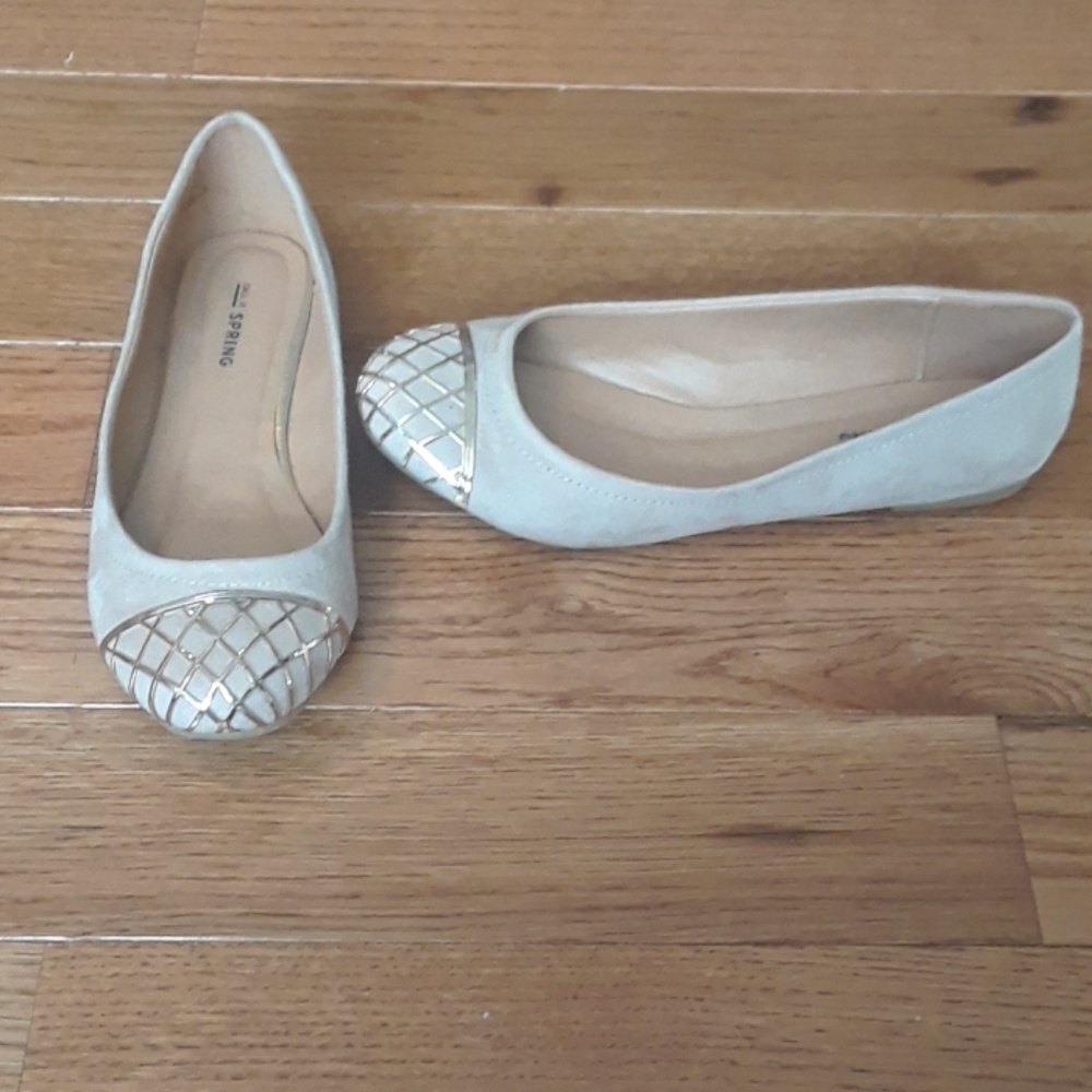 Beige flats with metal toe designs